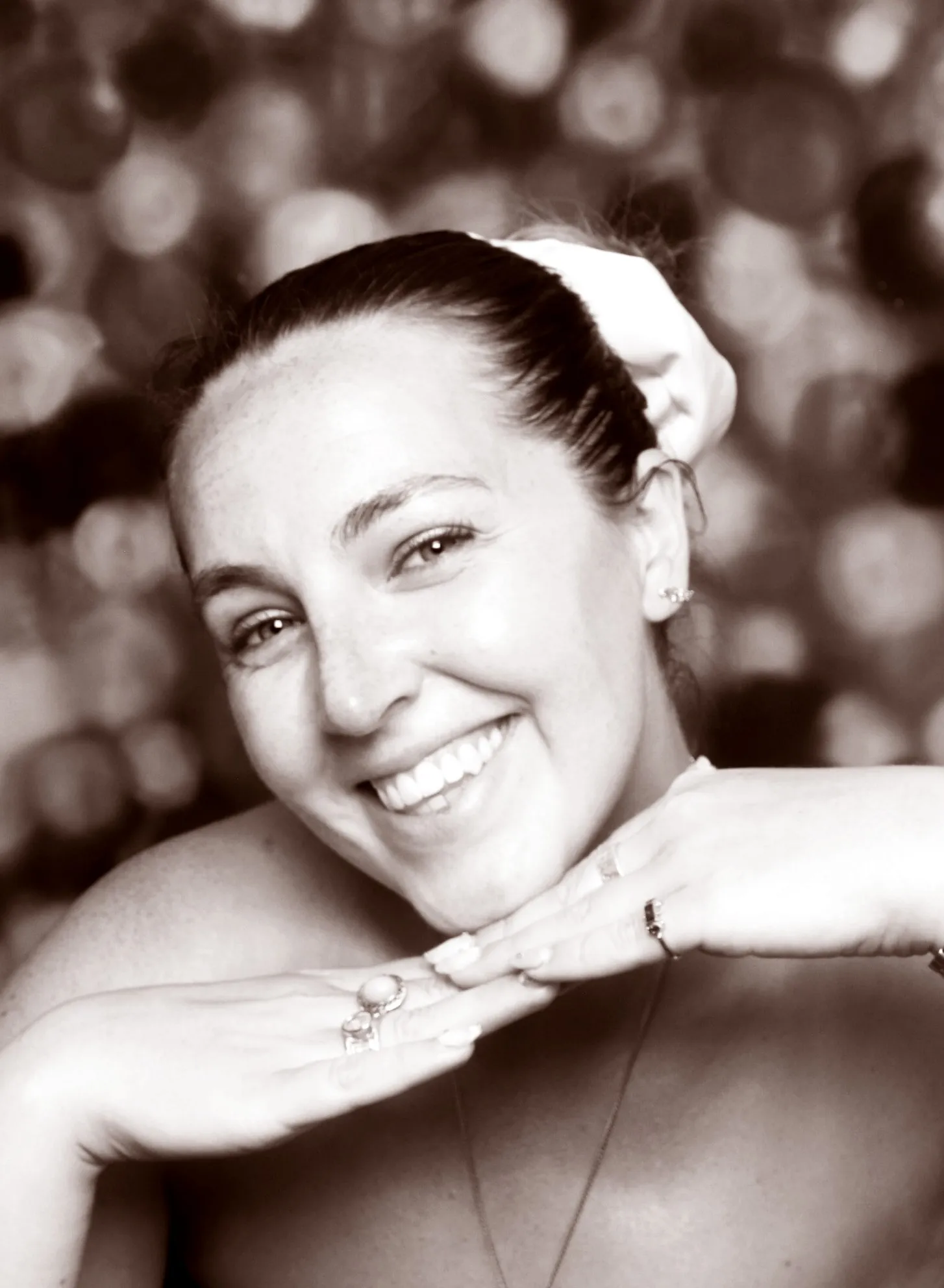 Katie, laughing, in a photo-booth portrait